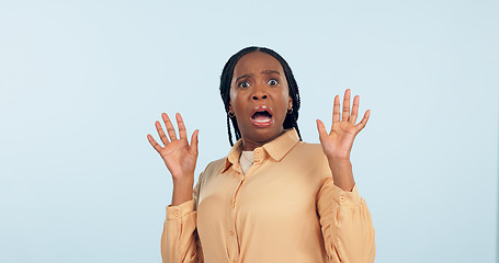 Image showing Black woman, fear and shock in studio portrait for anxiety, drama or secret with hands in air by blue background. African girl, wow and scared face for alarm, surprise or mind blown with announcement