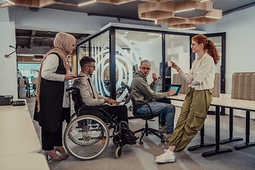 Image showing Young group of business people brainstorming together in a startup space, discussing business projects, investments, and solving challenges.