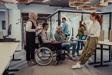 Image showing Young group of business people brainstorming together in a startup space, discussing business projects, investments, and solving challenges.