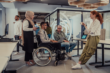 Image showing Young group of business people brainstorming together in a startup space, discussing business projects, investments, and solving challenges.