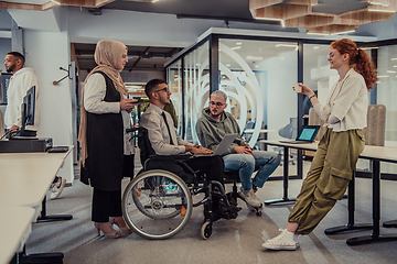 Image showing Young group of business people brainstorming together in a startup space, discussing business projects, investments, and solving challenges.