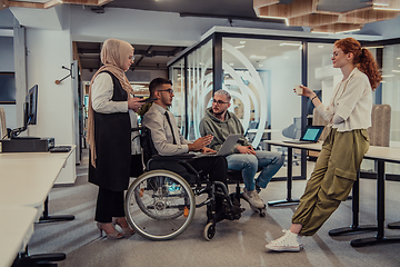 Image showing Young group of business people brainstorming together in a startup space, discussing business projects, investments, and solving challenges.