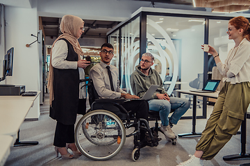 Image showing Young group of business people brainstorming together in a startup space, discussing business projects, investments, and solving challenges.