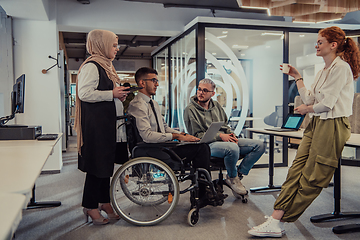 Image showing Young group of business people brainstorming together in a startup space, discussing business projects, investments, and solving challenges.