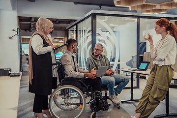 Image showing Young group of business people brainstorming together in a startup space, discussing business projects, investments, and solving challenges.