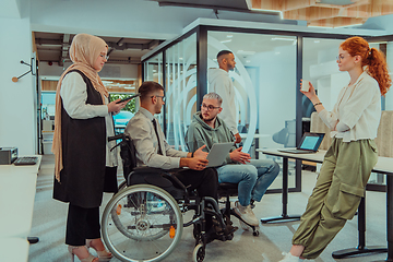 Image showing Young group of business people brainstorming together in a startup space, discussing business projects, investments, and solving challenges.