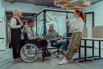 Image showing Young group of business people brainstorming together in a startup space, discussing business projects, investments, and solving challenges.