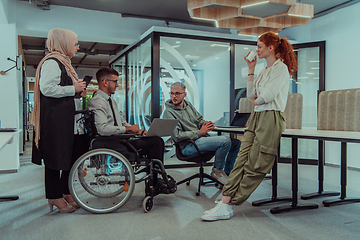 Image showing Young group of business people brainstorming together in a startup space, discussing business projects, investments, and solving challenges.