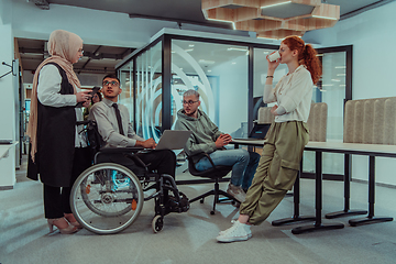 Image showing Young group of business people brainstorming together in a startup space, discussing business projects, investments, and solving challenges.