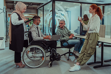 Image showing Young group of business people brainstorming together in a startup space, discussing business projects, investments, and solving challenges.