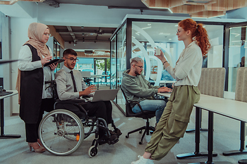 Image showing Young group of business people brainstorming together in a startup space, discussing business projects, investments, and solving challenges.