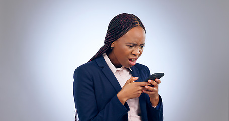 Image showing Stress, phone and confused black woman frustrated by text in studio with fake news, review or feedback on grey background. Surprise, anxiety and African entrepreneur shocked by social media hacker