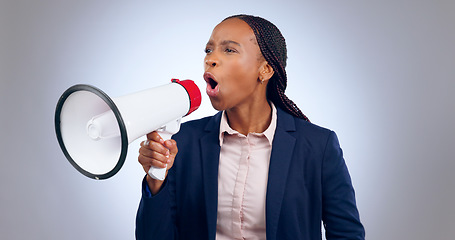 Image showing Megaphone, speech and angry business woman in studio for change, transformation or freedom on grey background. Corporate, justice and female speaker with bullhorn noise for announcement attention