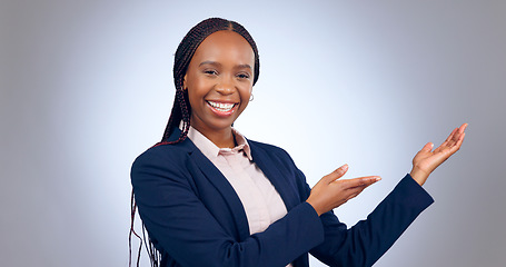 Image showing Portrait, business woman and presentation of space, mockup or announcement of promotion in studio on grey background. Happy african worker advertising launch of deal, feedback or information about us