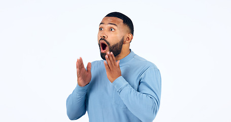 Image showing News, announcement and man with surprise on face in studio, white background or mockup space. Wow, emoji and excited or shocked person with secret, drama or hearing crazy information on promotion