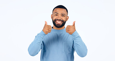 Image showing Thumbs up, man and portrait with sign for yes in studio, white background with happiness, support. Thank you, hands and person smile for success, agreement or positive emoji with achievement of goal