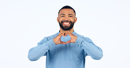 Image showing Heart, hands and portrait of man in studio for kindness, happy icon and charity donation on white background. Smile, love and emoji sign for hope, wellness and thank you for support, care and peace