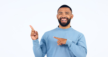 Image showing Man, portrait and pointing in studio for advertising information, deal or choice on white background. Happy model, presentation or show mockup space for feedback, promotion or launch of news about us