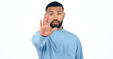 Image showing Stop, hand and portrait of man in studio with limits, control or warning order on white background. Protest, palm and face of male model with emoji vote, dont or no, rejection or not allowed sign