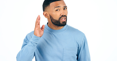 Image showing Portrait, secret or gossip with a man listening in studio isolated on a white background for communication. Face, hand and hearing with a young person looking confused about news, audio or sound