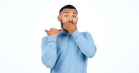 Image showing Shock, pointing and portrait of man in a studio with wow, omg or wtf facial expression for news. Surprise, emoji and face of young male person from Colombia isolated by white background with mockup.