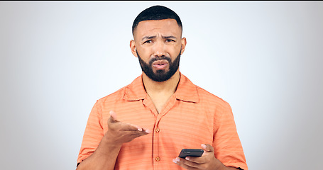 Image showing Portrait of man in studio with phone, frustrated and confused with connection problem, 404 or glitch. Communication, anger and person with smartphone with scam, phishing or fraud on white background.