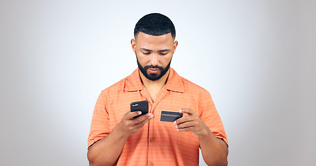 Image showing Man, smartphone and credit card in studio for online shopping, fintech payment and digital account on white background. Mobile banking, password and code for ecommerce app, sales or financial savings