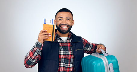 Image showing Travel, portrait and man with a passport, suitcase and vacation with a smile on white studio background. Face, model and tourist with tickets, luggage and travelling with mockup space and holiday