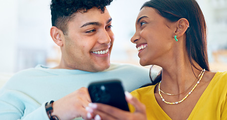 Image showing Couple, phone and happy on sofa, laugh or reading for funny story, notification or post on web blog. Man, woman and smartphone for meme, streaming comic video or memory on social network app in home