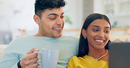 Image showing Couple, laptop and coffee on couch, laugh or reading for funny story, notification or post on web. Man, woman and computer for meme, streaming comic movie or happy on social network website in home