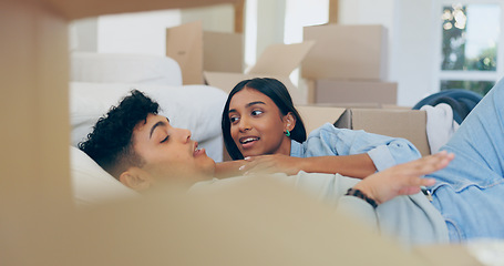 Image showing Couple, talk and relax after move to new home by lying on sofa in living room with boxes. Married people, bonding and ready for future with property investment, mortgage loan or sale in real estate