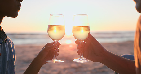 Image showing Sunset, beach and couple with wine, toast and anniversary with happiness, marriage and vacation. Romance, man and woman with alcohol, cheers or relationship with seaside holiday, lens flare or luxury