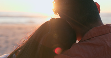 Image showing Sunset, beach and back of couple hug in nature for travel, bond or weekend freedom with lens flare. Sunrise, love and rear view or people embrace at sea for adventure, journey or romance at the ocean