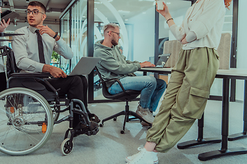 Image showing Young group of business people brainstorming together in a startup space, discussing business projects, investments, and solving challenges.