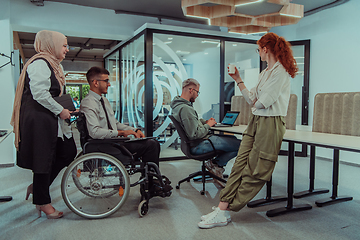 Image showing Young group of business people brainstorming together in a startup space, discussing business projects, investments, and solving challenges.