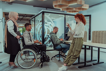 Image showing Young group of business people brainstorming together in a startup space, discussing business projects, investments, and solving challenges.