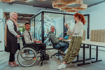 Image showing Young group of business people brainstorming together in a startup space, discussing business projects, investments, and solving challenges.