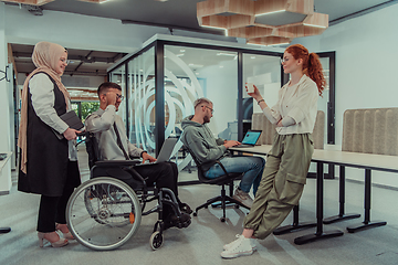 Image showing Young group of business people brainstorming together in a startup space, discussing business projects, investments, and solving challenges.