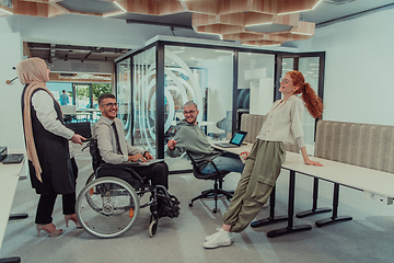 Image showing Young group of business people brainstorming together in a startup space, discussing business projects, investments, and solving challenges.