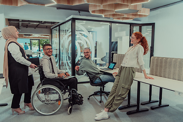 Image showing Young group of business people brainstorming together in a startup space, discussing business projects, investments, and solving challenges.