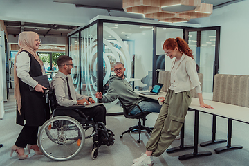 Image showing Young group of business people brainstorming together in a startup space, discussing business projects, investments, and solving challenges.