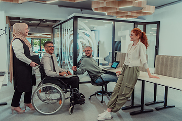 Image showing Young group of business people brainstorming together in a startup space, discussing business projects, investments, and solving challenges.