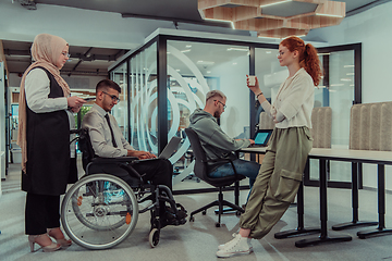 Image showing Young group of business people brainstorming together in a startup space, discussing business projects, investments, and solving challenges.