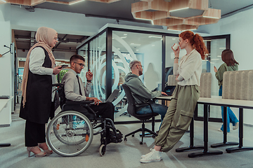 Image showing Young group of business people brainstorming together in a startup space, discussing business projects, investments, and solving challenges.