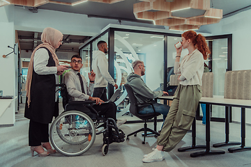 Image showing Young group of business people brainstorming together in a startup space, discussing business projects, investments, and solving challenges.