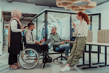 Image showing Young group of business people brainstorming together in a startup space, discussing business projects, investments, and solving challenges.