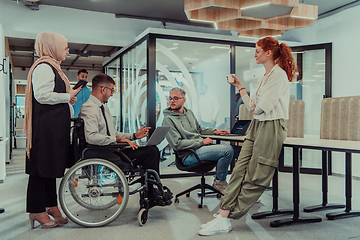 Image showing Young group of business people brainstorming together in a startup space, discussing business projects, investments, and solving challenges.