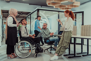 Image showing Young group of business people brainstorming together in a startup space, discussing business projects, investments, and solving challenges.