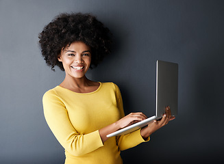 Image showing E learning, work and portrait of black woman with laptop, mockup and happiness in studio background. Computer, research and college student typing on keyboard for working, project or online class