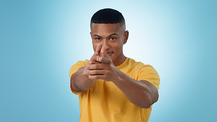 Image showing Portrait, finger gun and man aim at target in studio isolated on a blue background mockup space. Face, shooting hand gesture or African person pointing pistol weapon for self defence to kill criminal